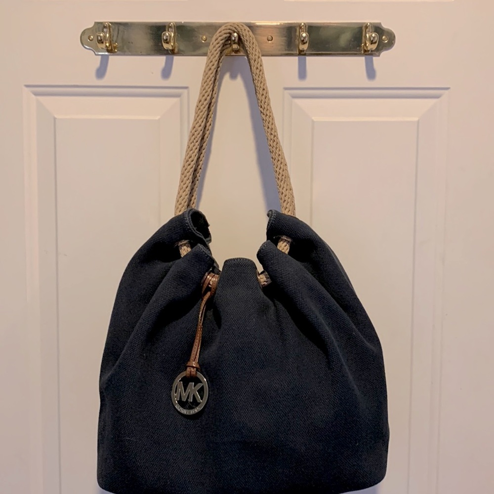 Michael Kors navy blue drawstring canvas bag. Drawstring is natural color.